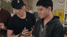 a man wearing a hat with the letter a on it is smiling