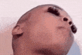 a close up of a person 's face with their eyes closed and their mouth open .