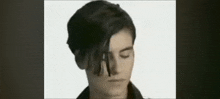 a close up of a person 's face with their eyes closed and their hair visible .