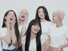 a group of young women are posing for a picture and one of them is laughing