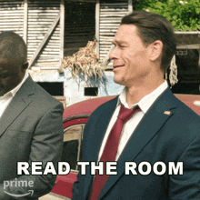 a man in a suit and tie is standing next to another man and says read the room