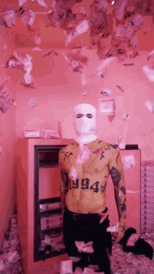 a shirtless man wearing a ski mask with the number 1994 on his chest
