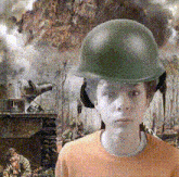 a boy wearing a green helmet and ear muffs