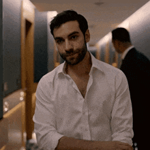 a man in a white shirt with his arms crossed