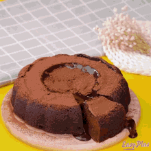 a chocolate cake on a cutting board with easy plus written on the bottom right