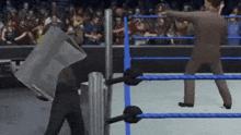 a man in a suit is standing in a wrestling ring holding a bag over his head .