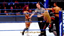 a woman in a wrestling ring is saying let 's go let 's go nataliya