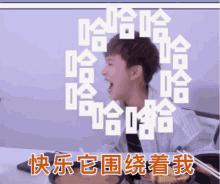 a man sitting at a table with chopsticks and chinese writing on the screen behind him