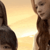 three women are standing next to each other and one of them is looking at the camera