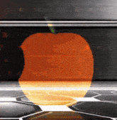 an orange apple with a green stem is displayed on a black background