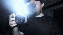 a man is taking a picture with a camera that has the word sony on it