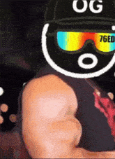 a man wearing sunglasses and a hat with the letters og on it