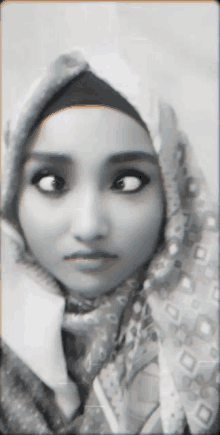 a black and white photo of a woman with a scarf around her head
