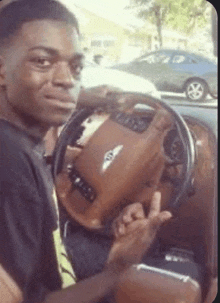 a man is sitting in the driver 's seat of a bentley