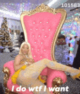 a woman is sitting in a pink chair that says " i do wtf i want " on it