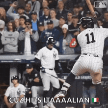 a baseball player with the number 11 on his jersey swings his bat
