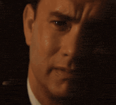 a close up of a man 's face in a dark room