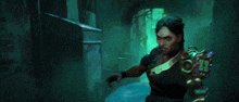 a woman is standing in a dark room with a sword in her hand .