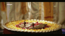 a cake with flowers on top of it and the hashtag #radhakrishna on the bottom