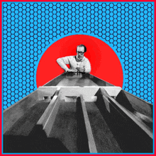 a man is looking down at a conveyor belt with a red circle in the middle