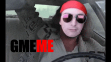 a man wearing sunglasses and a red headband is driving a car with the words gmeme written on the bottom