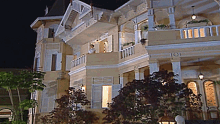 a large house with a balcony has the number 1021 on the front