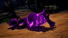 a purple monster is laying on the ground in the dark
