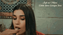 a close up of a woman 's face with the words " ask ve mavi " written above her