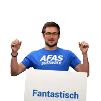 a man wearing a blue afas software shirt holds a sign