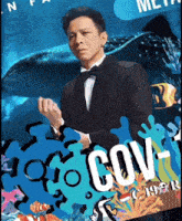 a man in a tuxedo stands in front of a whale shark and the word cov on a blue background
