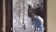 a person is standing in front of a door with a bear in the background and says `` it was worth it '' .