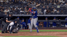 a baseball player getting ready to hit a ball in front of a bank of america banner