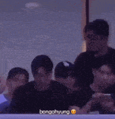 a group of people are sitting in a dark room with bongohyung written on the screen