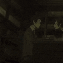 a couple of people are standing next to each other in a dark room in a dark room .