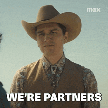 a man wearing a cowboy hat and vest says we 're partners