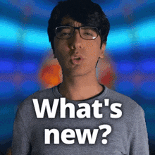 a man wearing glasses and a gray shirt says what 's new