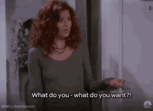 a woman with red hair is standing in front of a refrigerator and saying `` what do you what do you want ? ''