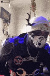 a person wearing a hat with a hello kitty on it and a patch that says " mad dawg dub "
