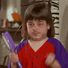 a man with a beard and a wig is holding a brush