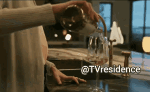 a woman is pouring wine into a glass with the words @tvresidence below it