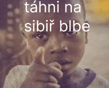 a blurry picture of a child pointing with the words tahni na sibir blbe above it