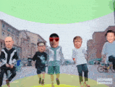 a group of people walking down a street with faces on them and the words face funny on the bottom right