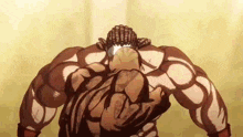 a muscular man with a braided head is standing in front of a wall .