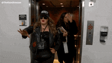 a woman wearing a hat that says security is standing in an elevator