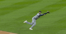 a baseball player with the letter g on his hat is laying on the grass