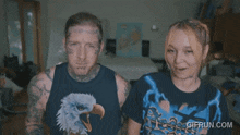 a man and a woman are standing next to each other and the woman is wearing a t-shirt with an eagle on it