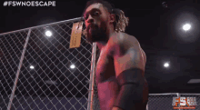 a man standing behind a chain link fence with the hashtag #fswnoescape on the bottom