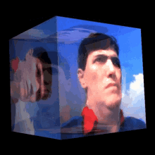 a man 's face is displayed in a cube with a blue sky in the background