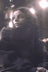 a blurry picture of a woman 's face with a light behind her