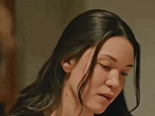a close up of a woman 's face with dark hair